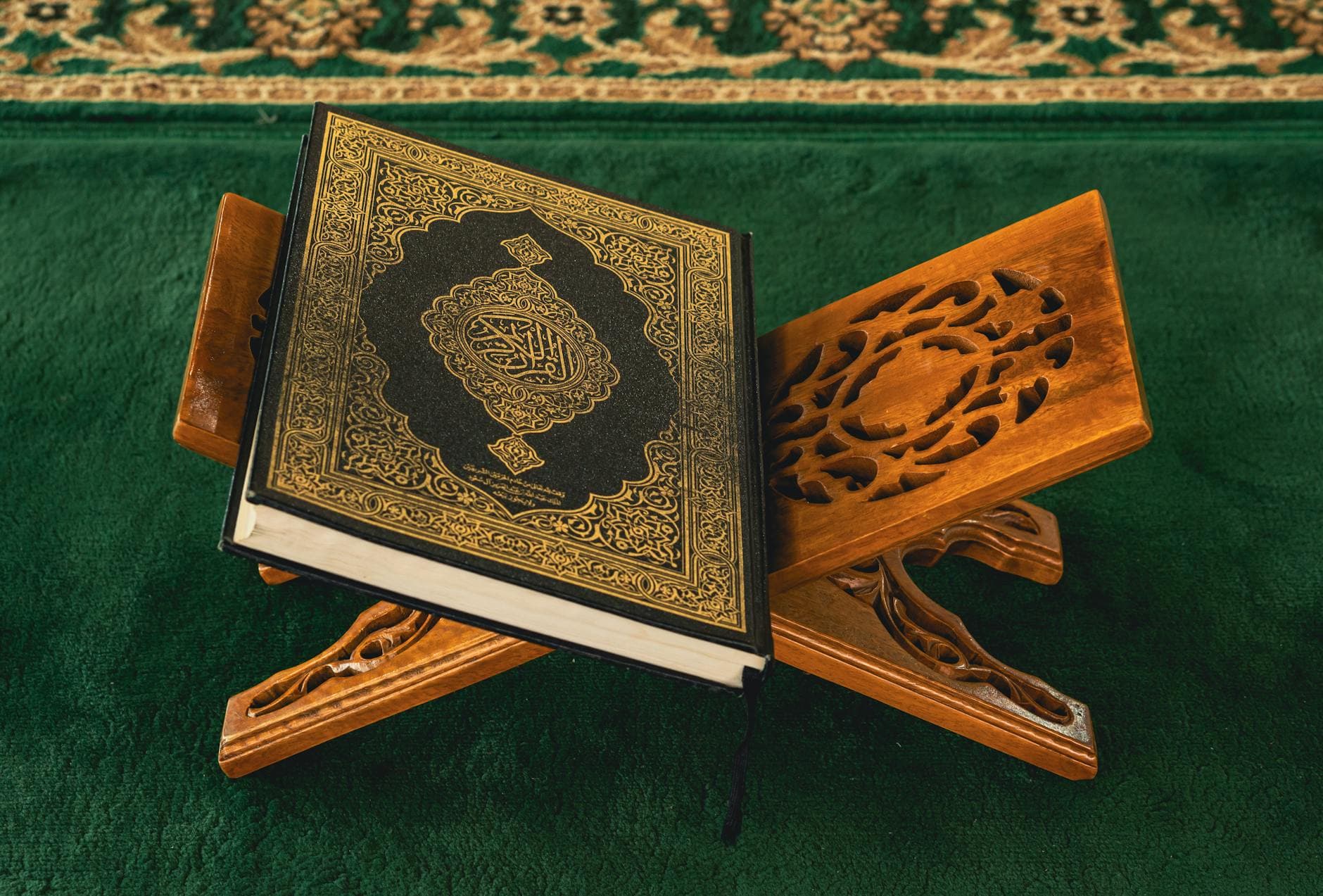 Photo by Defrino Maasy on Pexels A Quran displayed on an ornate wooden rehal in a mosque setting, symbolizing spirituality.
