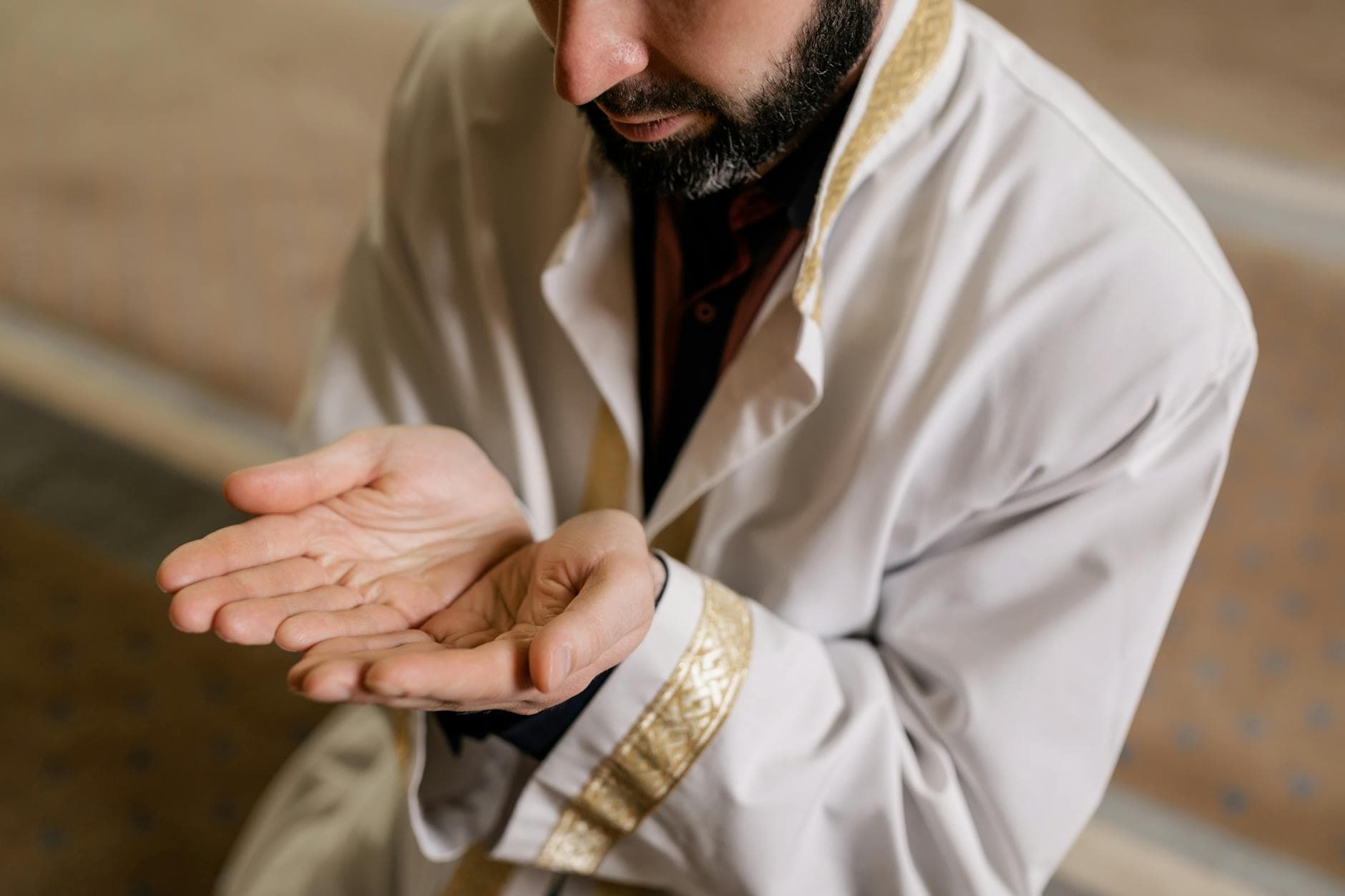 Photo by Alena Darmel on Pexels A Muslim man kneeling and praying inside a mosque, showcasing cultural and religious practices.