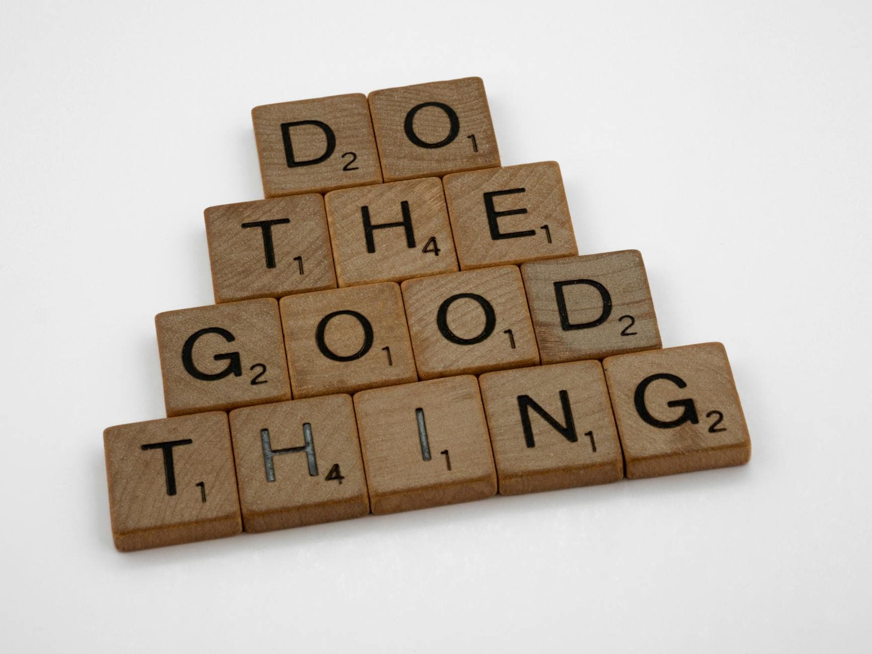 Photo by Brett Jordan on Pexels Wooden tiles arranged to spell 'Do The Good Thing,' promoting positive action.